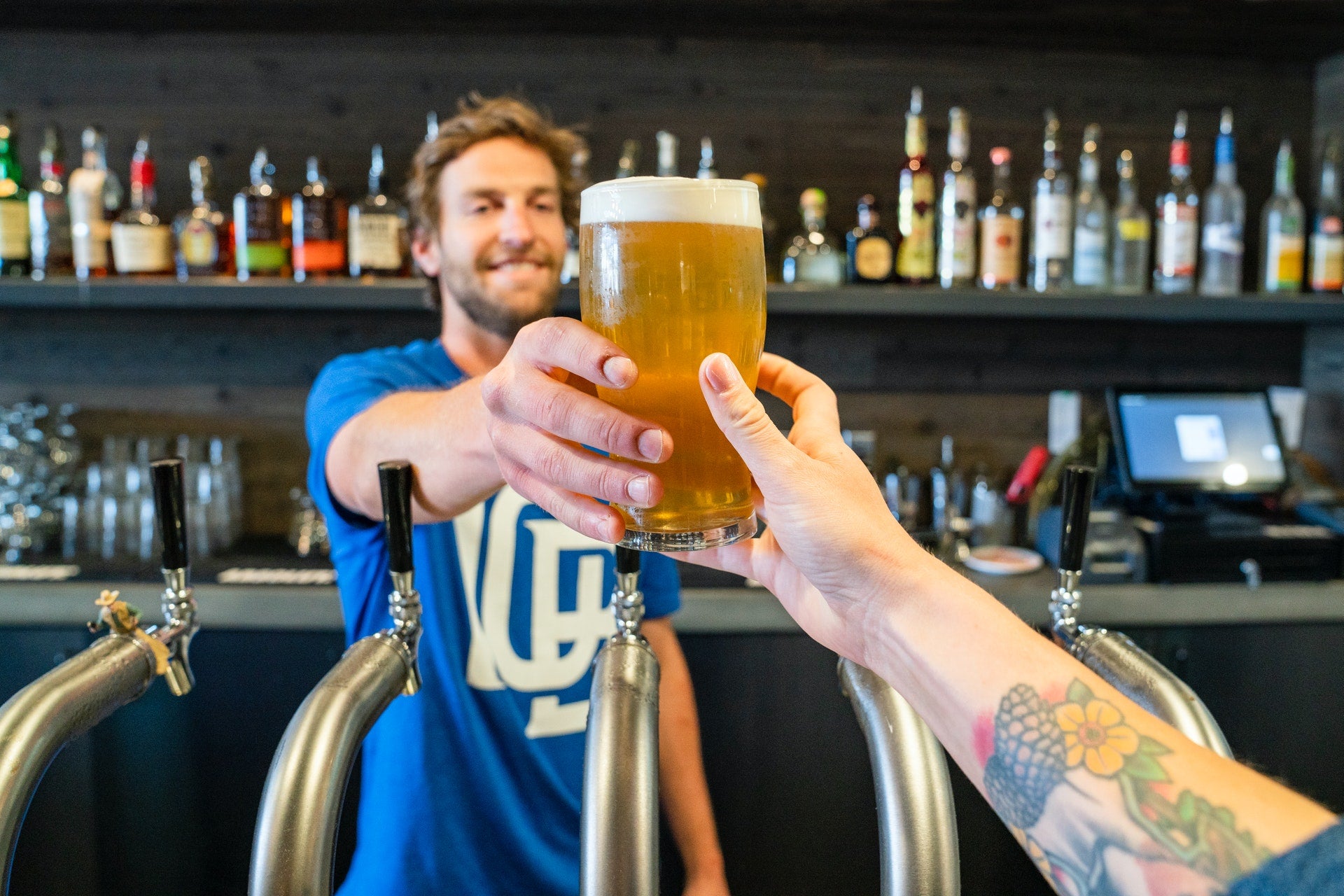 Man holding a glass of beer. Fuelled Nutrition