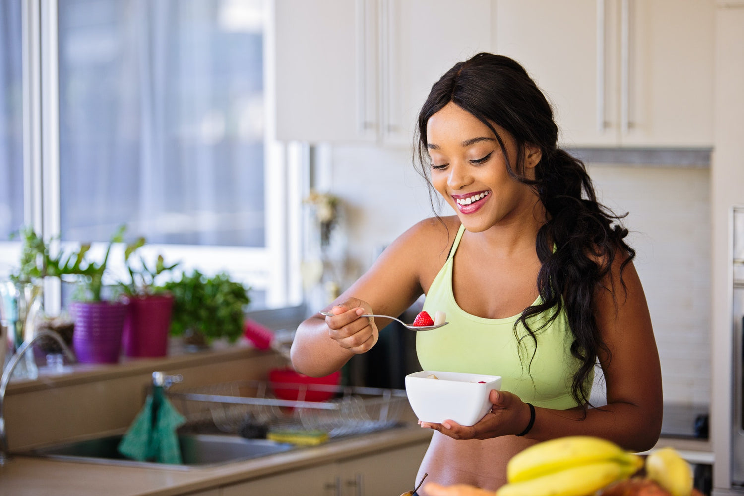 Girl eating a strawberry | Fuelled Nutrition