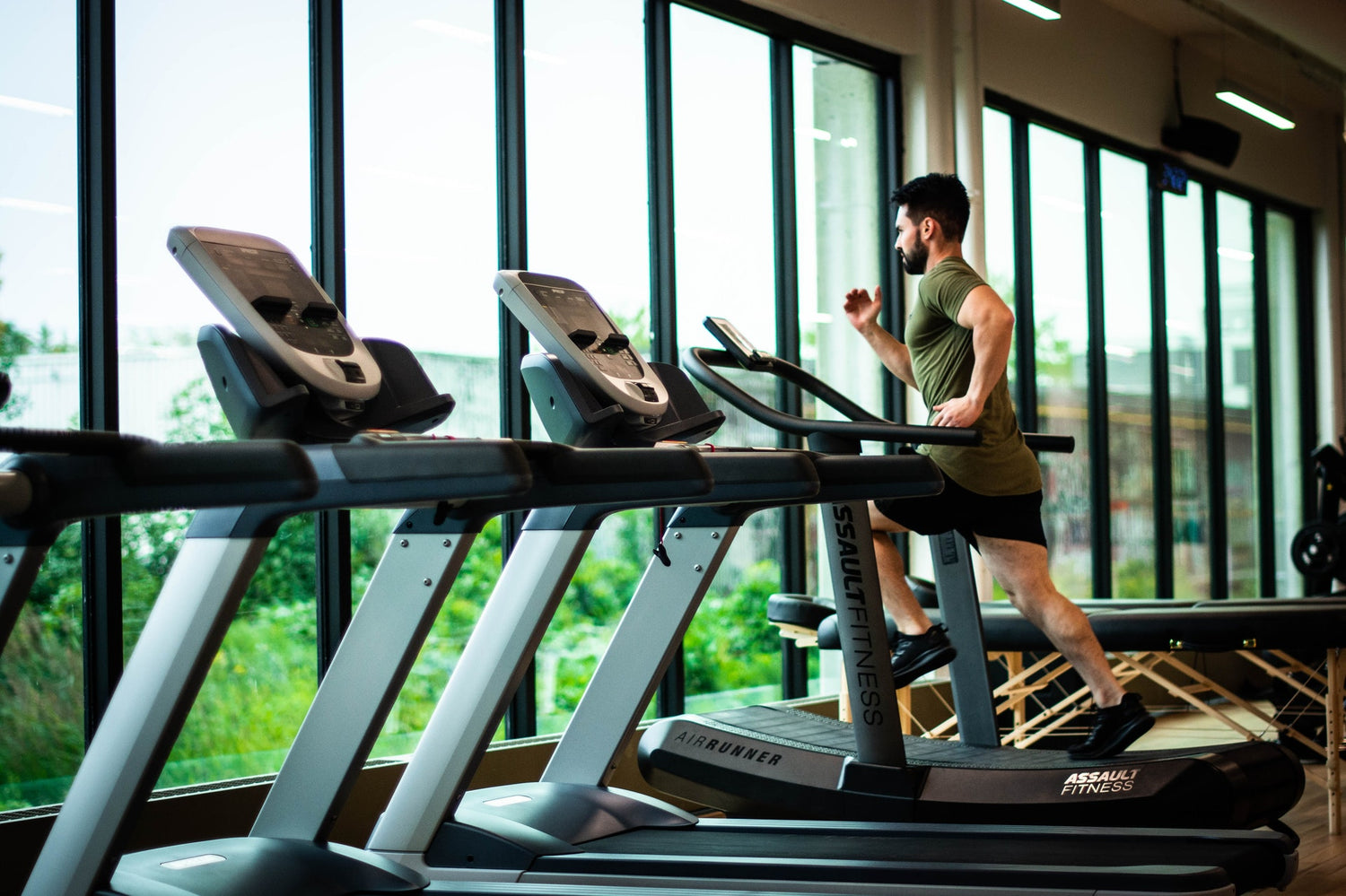 Guy running on treadmill. | Fuelled Nutrition